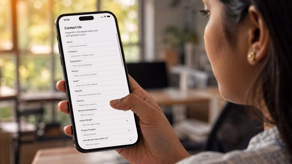  Indian professional hesitating over a long website contact form with eleven fields on a smartphone screen website mistakes killing conversions  
