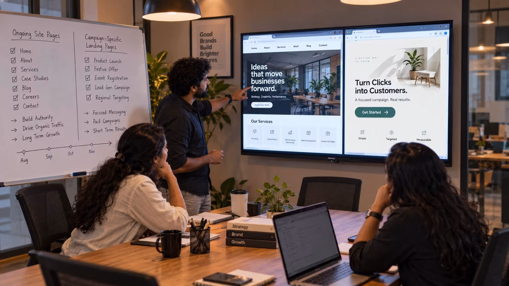 Three Indian creative professionals reviewing a website and landing page side by side on a meeting room monitor